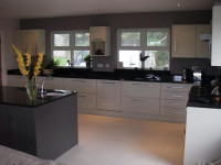 Grey, white and black kitchen with chrome handles